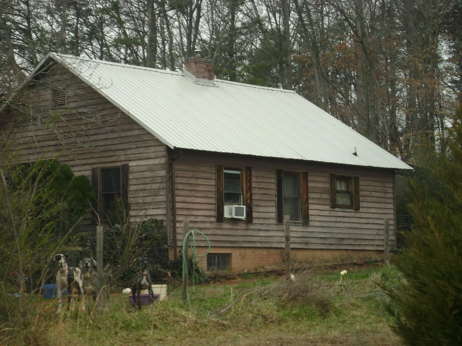 White metal roof on an old wood sided farmhouse, from a Metal Roof Installation job in Pearisburg